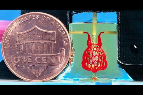An image showing a US one-cent coin shown next to a scale-model of a lung-mimicking air sac with airways and blood vessels.
